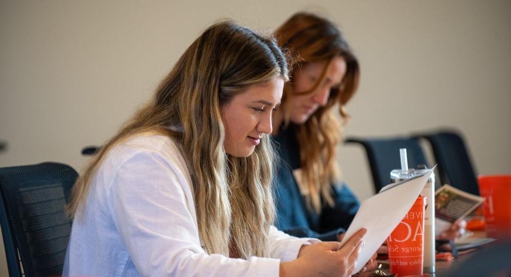 Photo of a student reading a handout